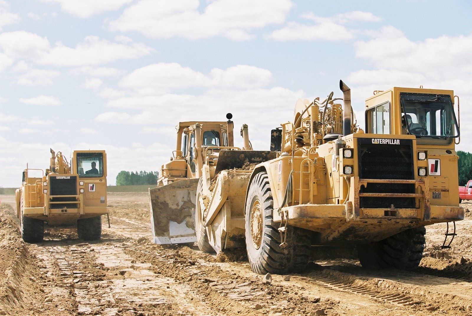 Dozer pushing grader during grader excavation operations.