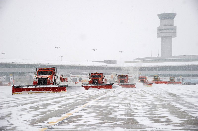 Convoy of snow plows working together during a snow removal operation at Toronto Pearson Airport 